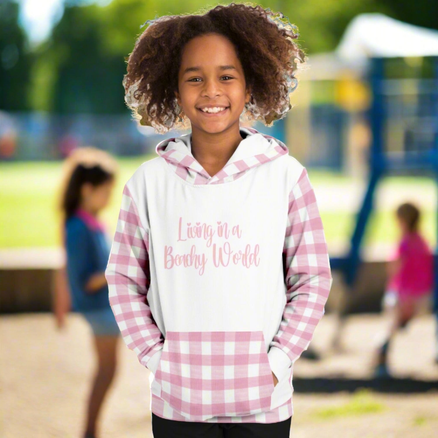 Custom girl's hoodie with white front and back and pink and white gingham sleeves, kangaroo pouch and hoodie that says Living in a Beachy World in fancy font