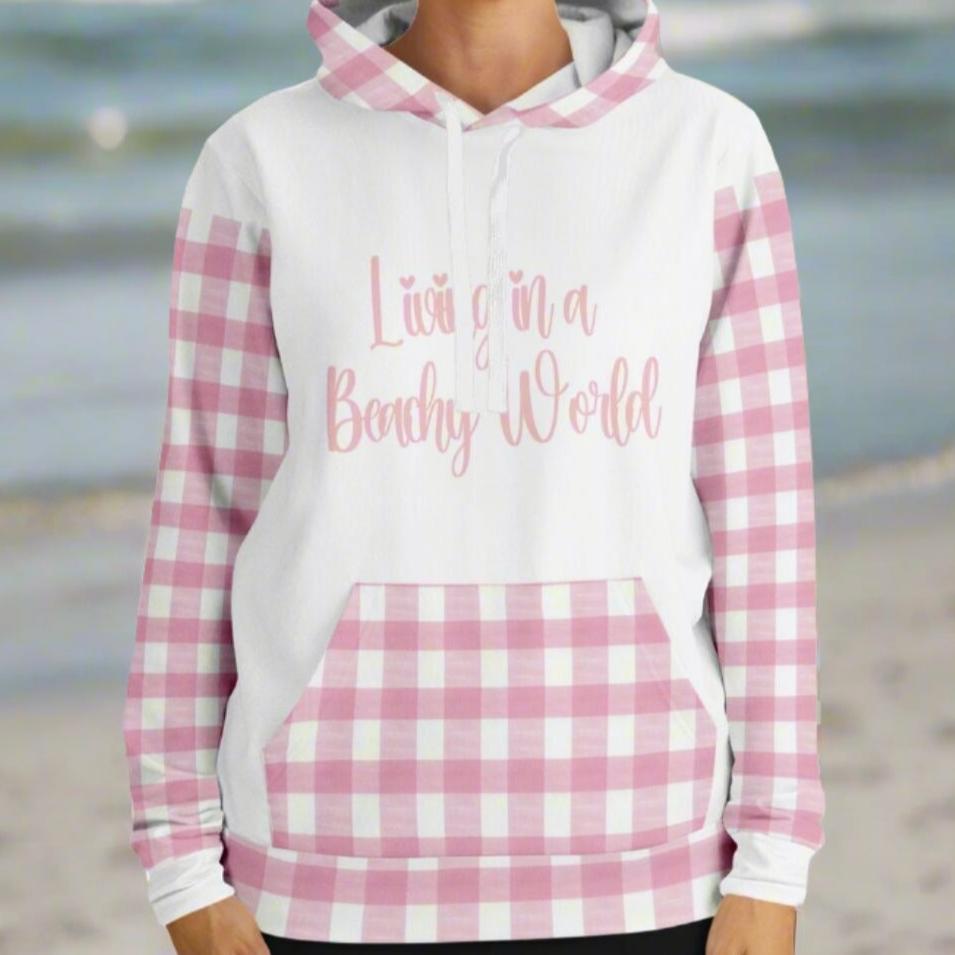 Custom Woman's hoodie with white front and back and pink and white gingham sleeves, kangaroo pouch and hoodie that says Living in a Beachy World in fancy font