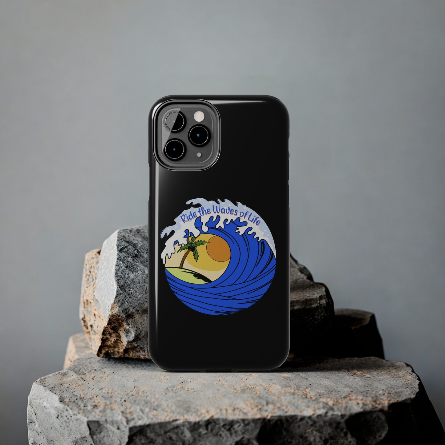 black Iphone Tough Case with a blue wave and sunset that says Ride the Waves of Life