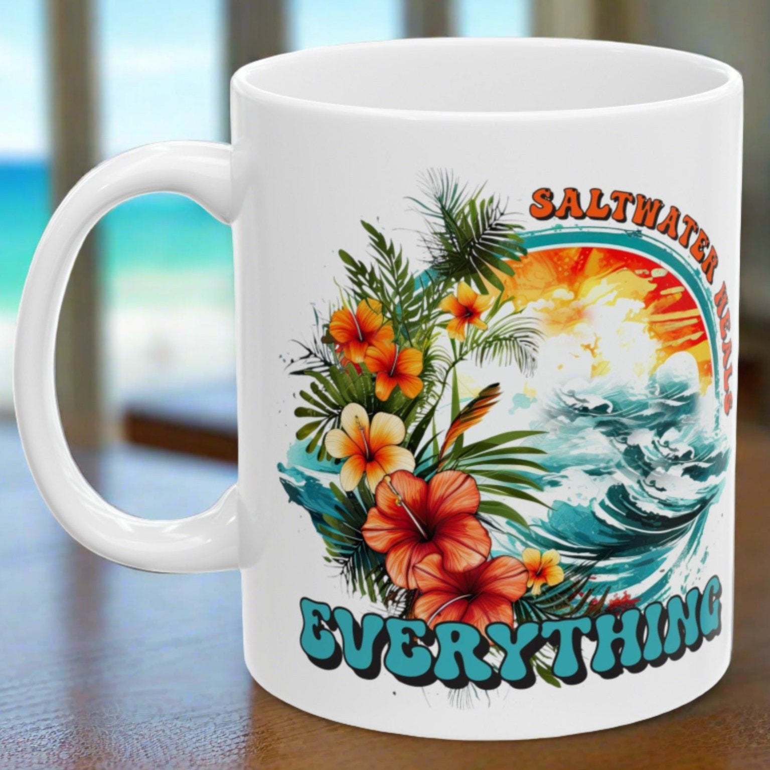 White ceramic mug that says Saltwater Heals Everything around ocean waves with tropical flowers