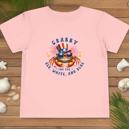 Pink t-shirt with a crab graphic and text on a white background