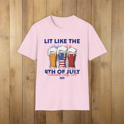 Pink t-shirt featuring three pint glasses—one filled with the American flag with slogan Lit Like the 4th of July Crescent City, CA 2025.