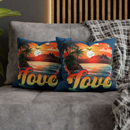 Two decorative 14" x 14" blue pillows with a sunset heart design and 'love' text on a gray couch.