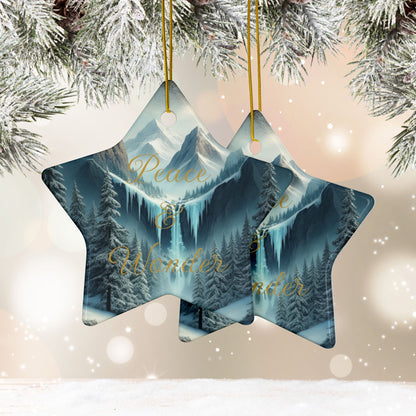 Star-shaped Christmas ornament with mountain and forest design, hanging against a snowy background.