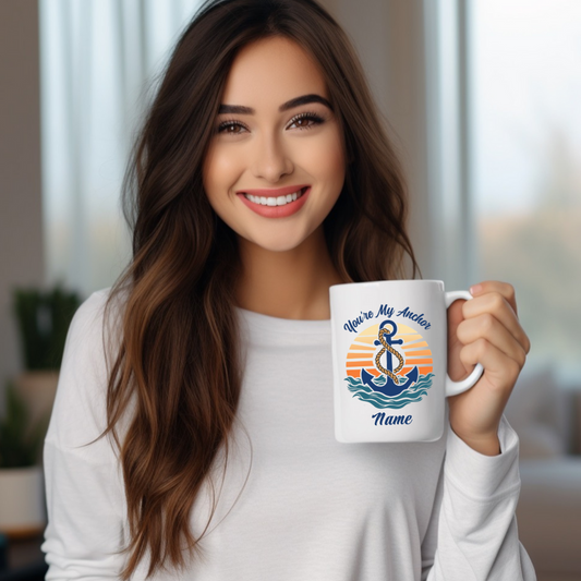 A white ceramic 15 oz mug with an anchor. Retro sunset and waves that says You're My Anchor and personalize with a name.