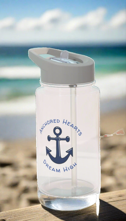 Clear water bottle with a blue anchor and the words Anchored Hearts and Dream High surrounding the anchor.