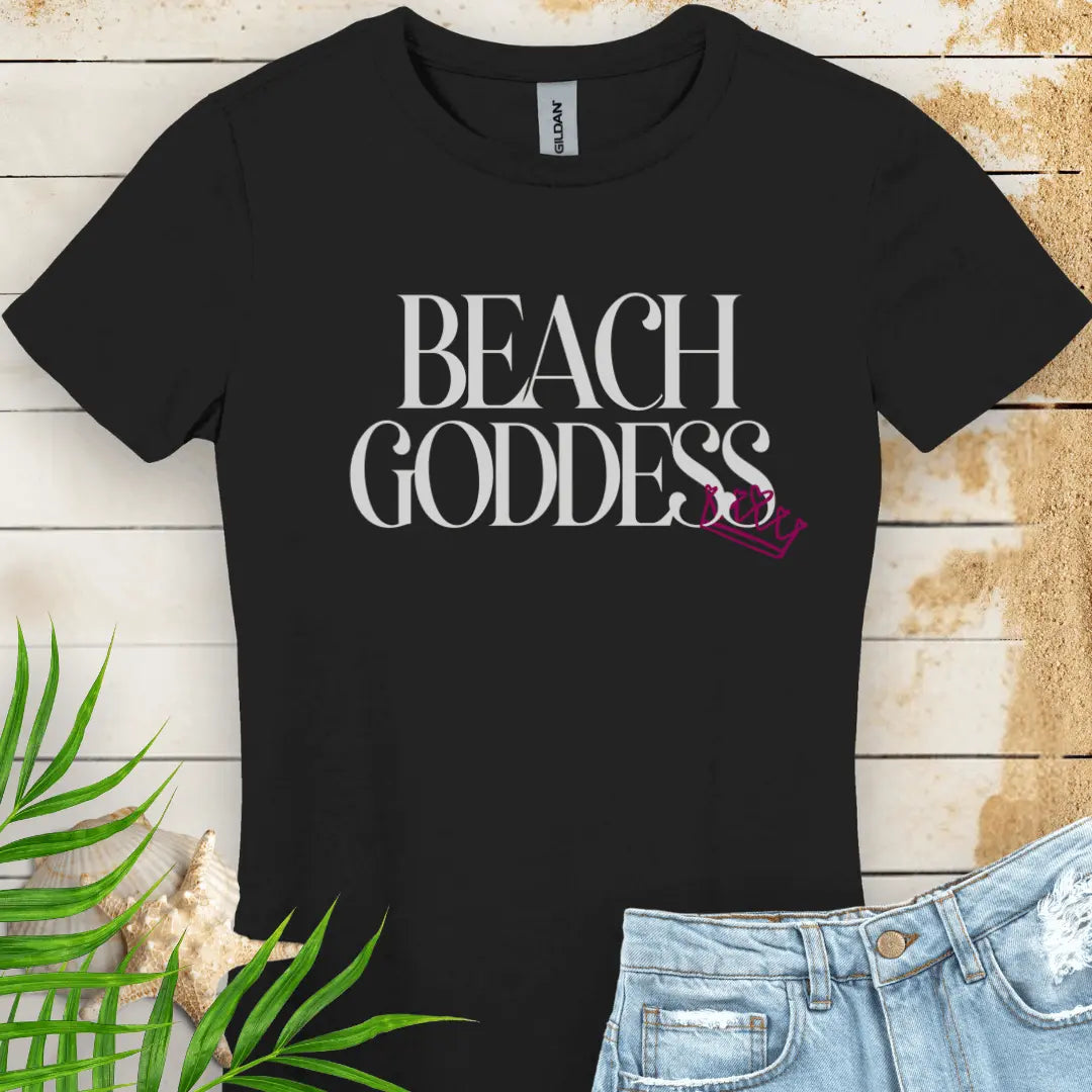Black Women's T-Shirt with the text Beach Goddess with a crown hanging off of the bottom of the text -stylish tee is great for vacations, beach days, or casual wear.