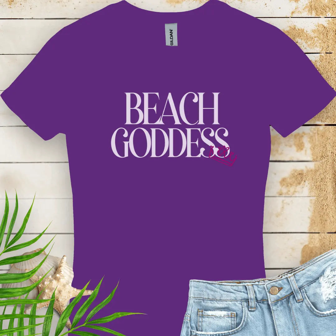 Purple Women's T-Shirt with the text Beach Goddess with a crown hanging off of the bottom of the text -stylish tee is great for vacations, beach days, or casual wear.