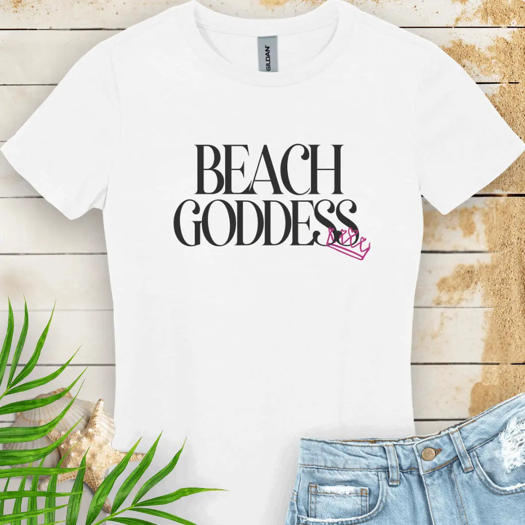 White Women's T-Shirt with the text Beach Goddess with a crown hanging off of the bottom of the text -stylish tee is great for vacations, beach days, or casual wear.