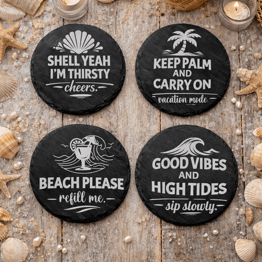 Set of four round black slate beach quote coasters engraved with “Shell Yeah I’m Thirsty,” “Keep Palm and Carry On,” “Beach Please refill me,” and “Good Vibes and High Tides.
