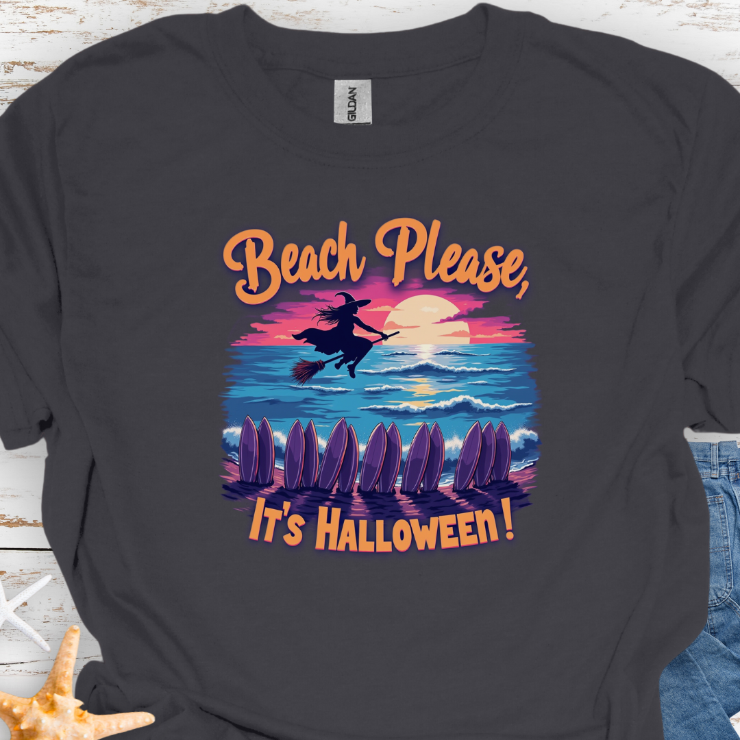 Charcoal  T-shirt with image of witch flying on a broom over the ocean with surfboards in the sand and text that says Beach Please, It's Halloween.