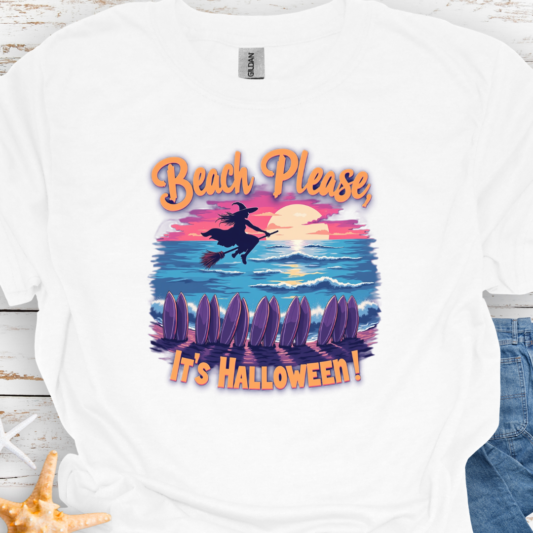 White  T-shirt with image of witch flying on a broom over the ocean with surfboards in the sand and text that says Beach Please, It's Halloween.