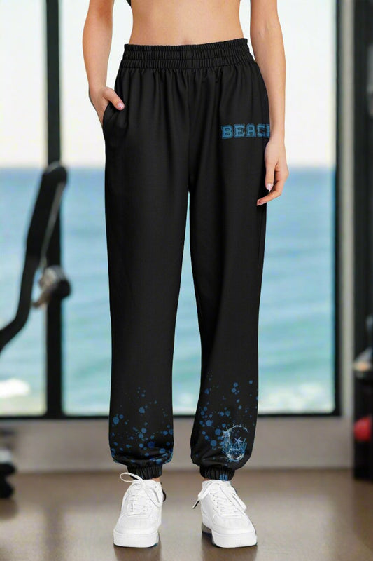 Black sweatpants with closed bottom college font text Beach on left by pocket and bubbles coming up from bottom with Beach Vibes and wave coming up around down at the bottom left leg.