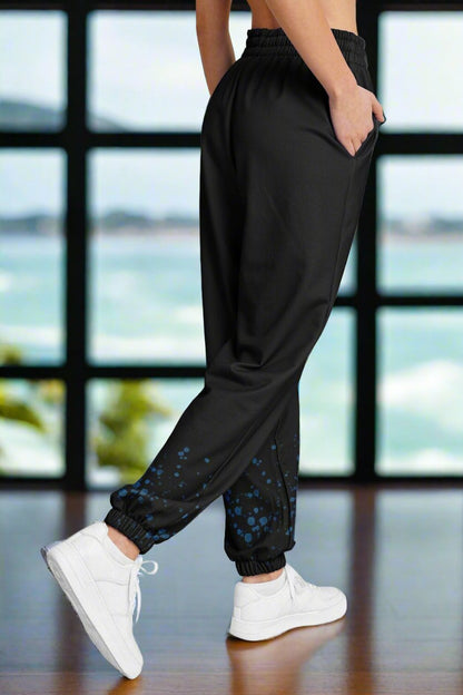 Side view of black sweatpants cinched at bottom with aqua colored bubbles coming up bottom.