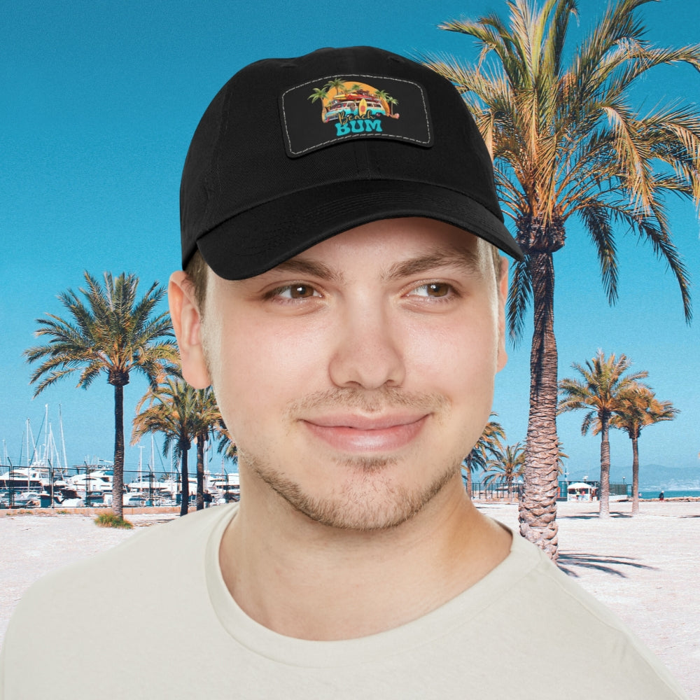 Man in black hat with leather patch that says beach bum with a beach van, surfboards, palm trees and sun.