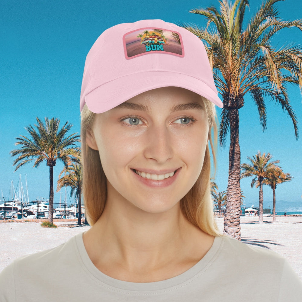 Woman in pink hat with leather patch that says beach bum with a beach van, surfboards, palm trees and sun.