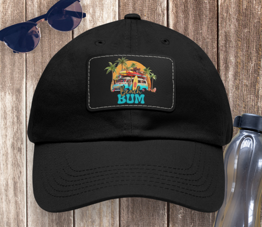 Black hat with black patch with ocean view of beach van with surf gear and sunset behind with text Beach Bum