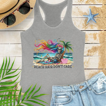 Gray  Racerback Tank Top with a skeleton with rainbow hair flowing in the wind laying on a beach chair at the ocean that says Beach Hair Don't Care.