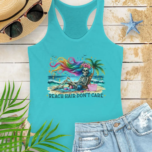Tahiti Racerback Tank Top with a skeleton with rainbow hair flowing in the wind laying on a beach chair at the ocean that says Beach Hair Don't Care.