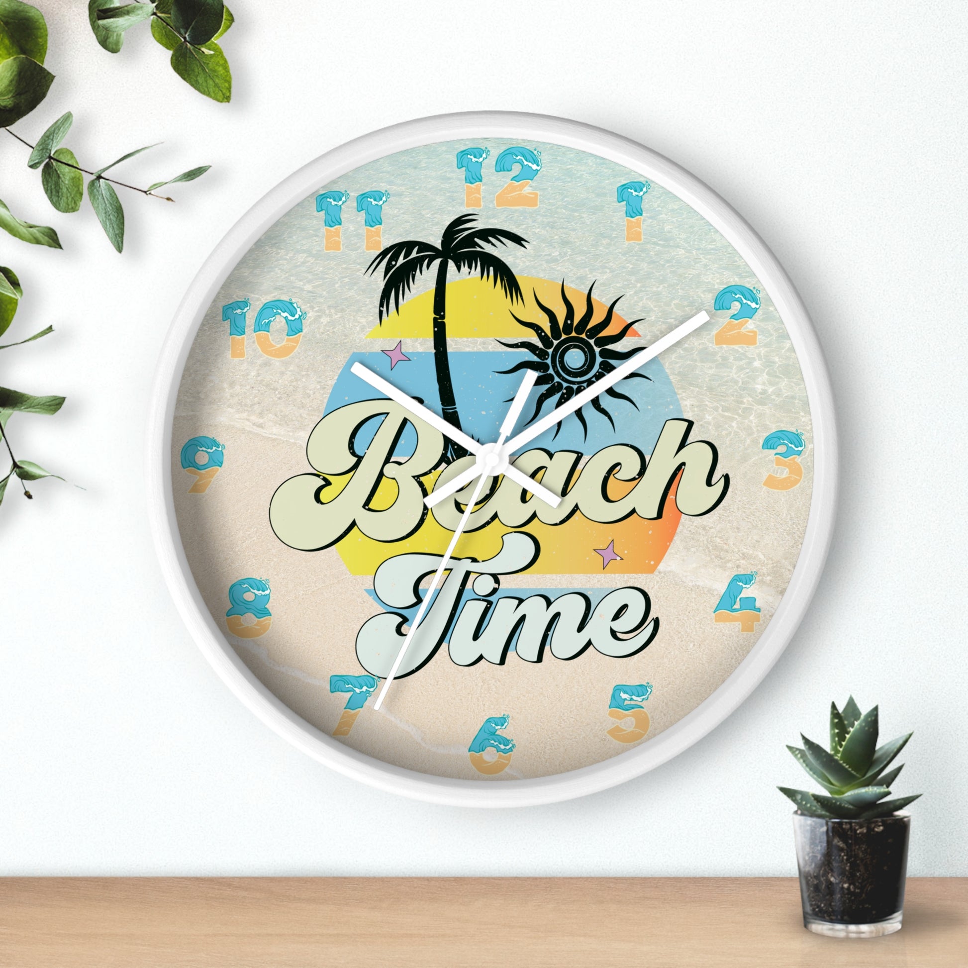 A circle wall clock with a white frame with white handles with an image of palm trees and sunset with a background of ocean water and sand that says Beach Time.