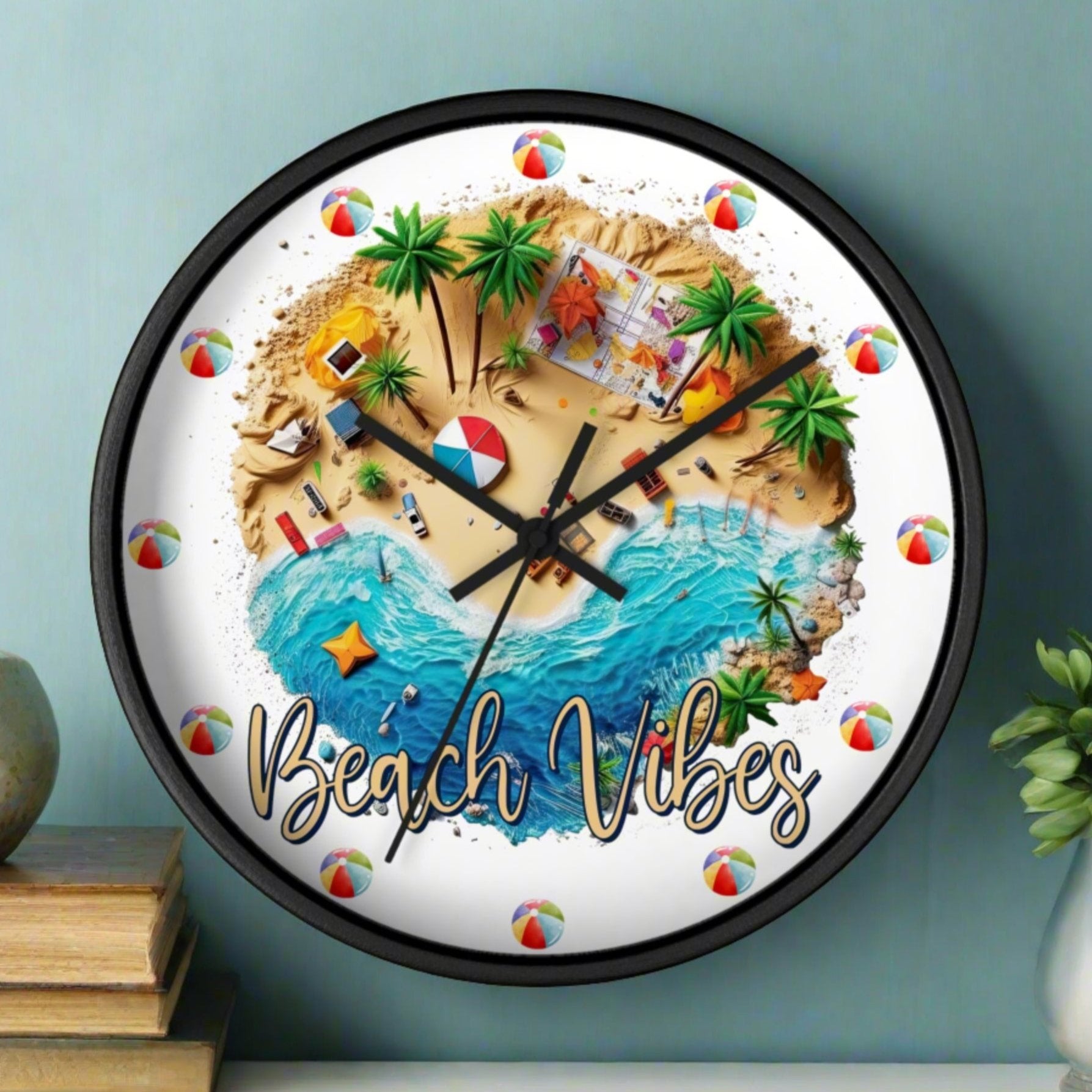 A round wall clock with a black frame, and black hands with a beach scene that says Beach Vibes and has beach balls in place of the numbers to show the time.