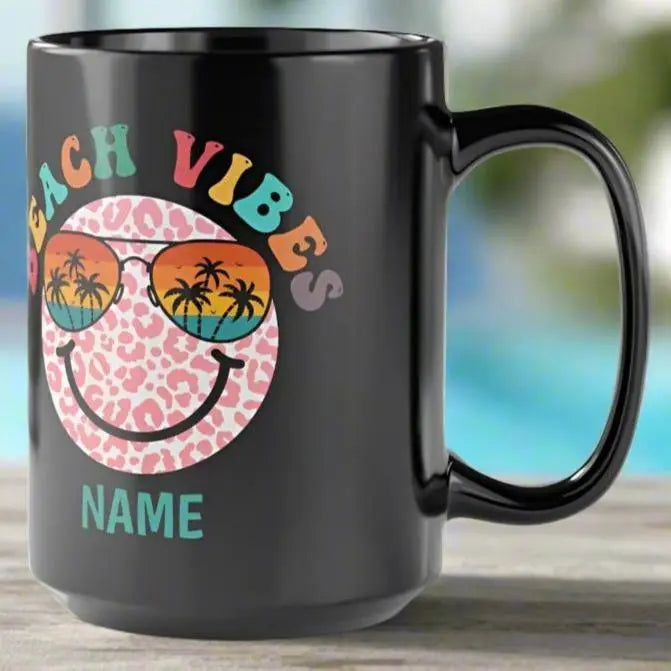 Black 15 oz ceramic mug with "Beach Vibes" colorful text, featuring a retro smiley face wearing sunset sunglasses with palm trees. Personalized with a name, this coastal-themed coffee mug is perfect for beach lovers and summer vibes.