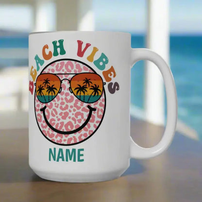 White 15 oz ceramic mug with "Beach Vibes" colorful text, featuring a retro smiley face wearing sunset sunglasses with palm trees. Personalized with a name, this coastal-themed coffee mug is perfect for beach lovers and summer vibes.