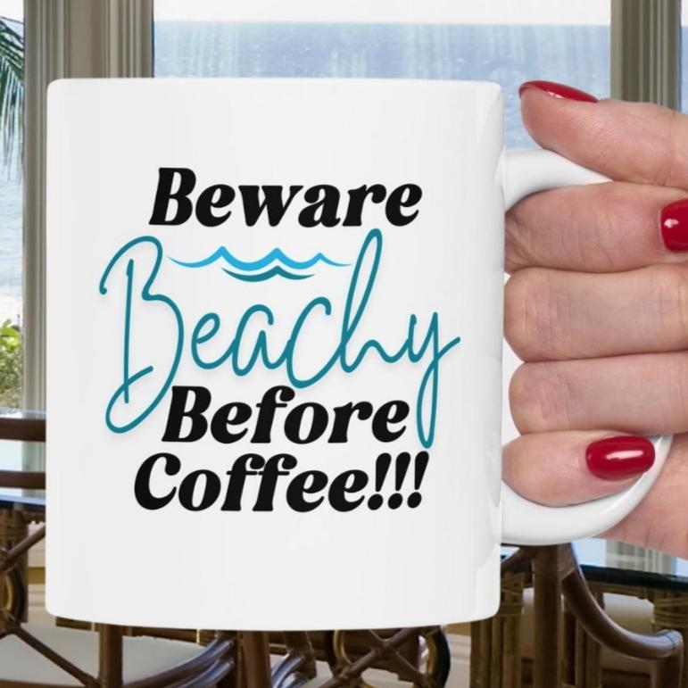 White coffee mug that says Beware Beachy Before coffee with wave image.