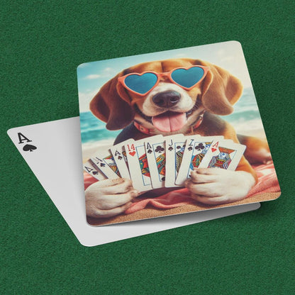 Playing cards with a beagle in heart glasses holding playing cards while laying on a beach