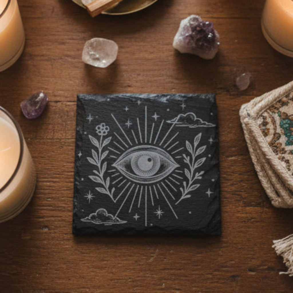 Decorative engraved slate tile with celestial boho eye design and floral elements.