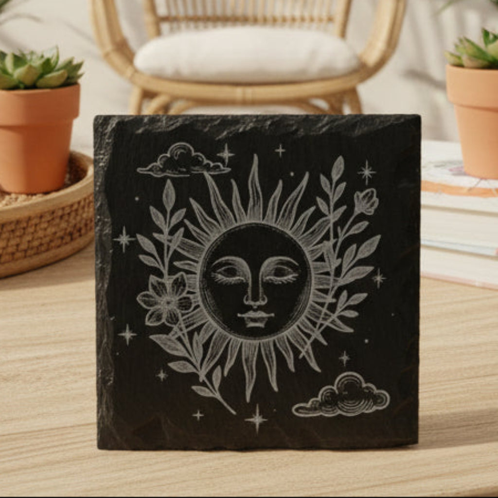 Decorative slate with sun and moon celestial boho design.