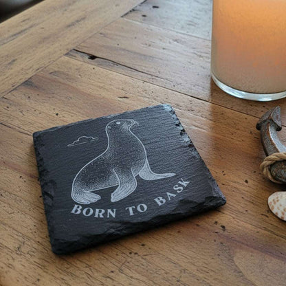 Slate coaster with seal design and 'Born to Bask' text engraved.