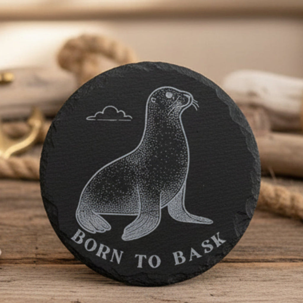 Black engraved 4" circle slate coaster with a seal illustration and 'Born to Bask' text.