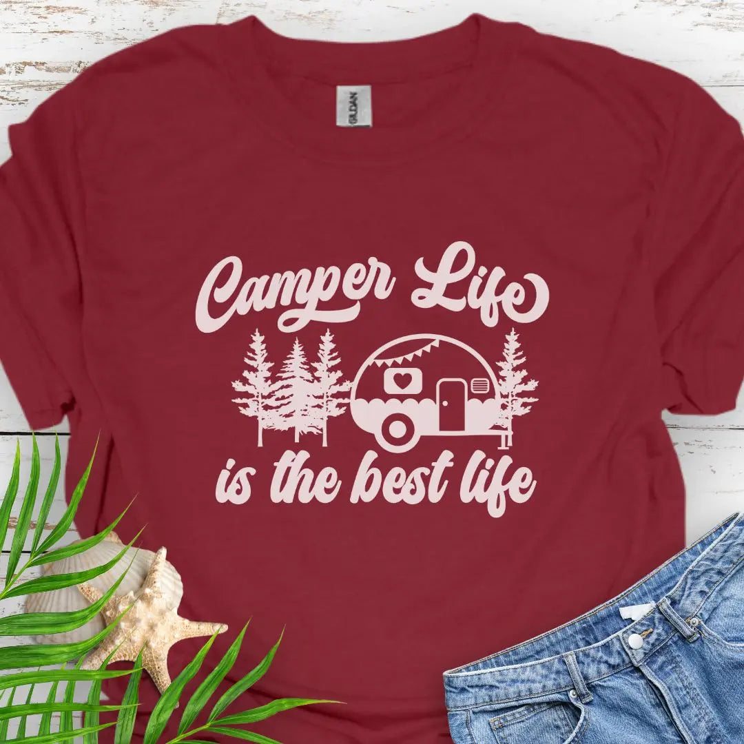 A cute vintage camper among the forest that says Camper Life is the good life in Maroon.