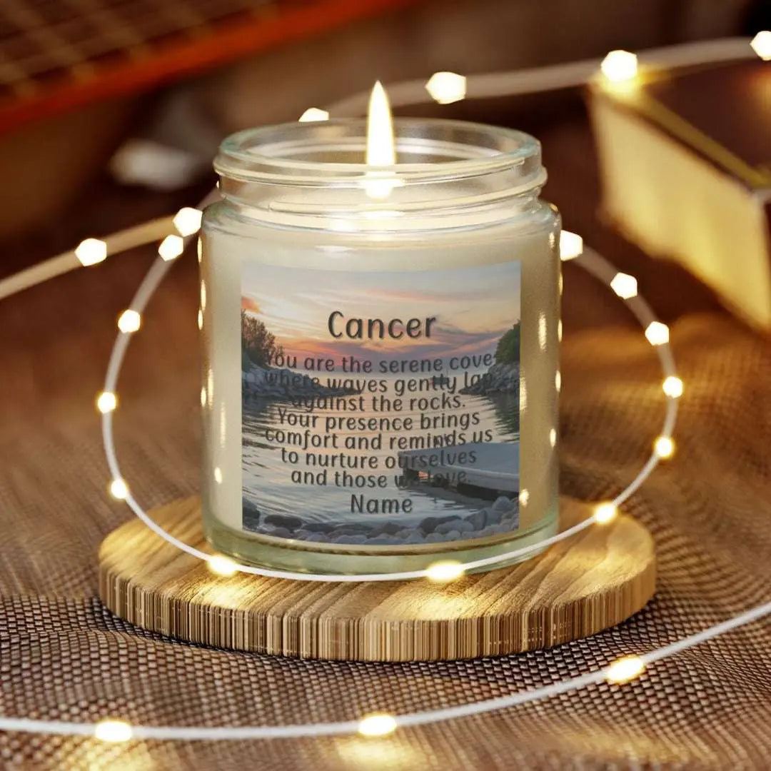 Elegant Cancer Zodiac hand-poured coconut apricot wax scented candle in a 4 oz clear glass jar, featuring a serene water and boat dock scene at sunset and an inspirational quote personalized. A beach-inspired astrology gift, perfect for relaxation and decor.