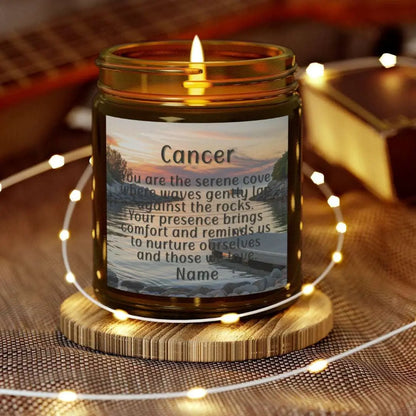 Elegant Cancer Zodiac hand-poured coconut apricot wax scented candle in a 9 oz amber glass jar, featuring a serene water and boat dock scene at sunset and an inspirational quote personalized. A beach-inspired astrology gift, perfect for relaxation and decor.