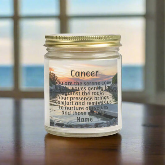 Elegant Cancer Zodiac hand-poured coconut apricot wax scented candle in a 9 oz clear glass jar with gold lid, featuring a serene water and boat dock scene at sunset and an inspirational quote personalized. A beach-inspired astrology gift, perfect for relaxation and decor.