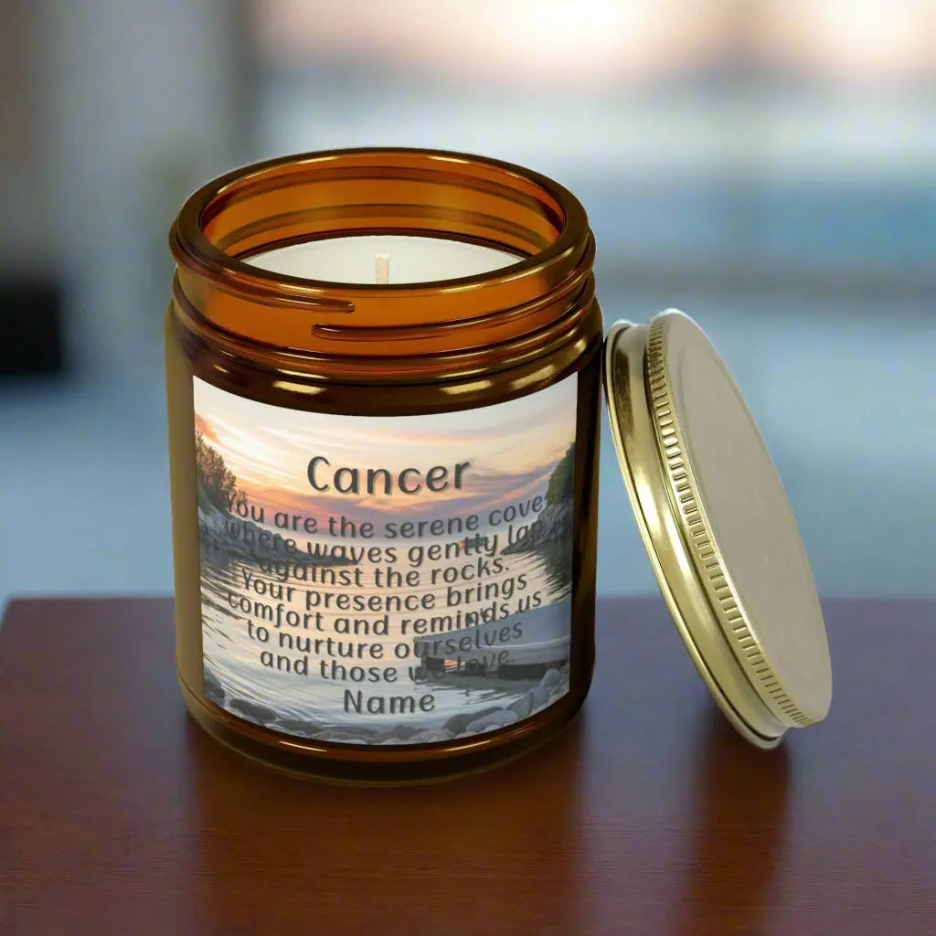 Elegant Cancer Zodiac hand-poured coconut apricot wax scented candle in a 9 oz amber glass jar with a gold lid, featuring a serene water and boat dock scene at sunset and an inspirational quote personalized. A beach-inspired astrology gift, perfect for relaxation and decor.