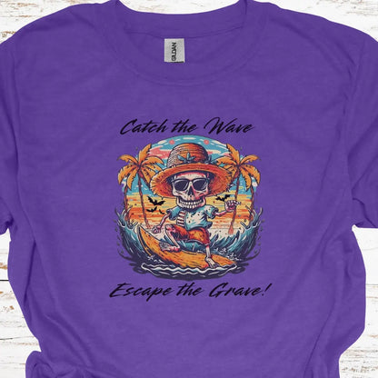 Heather Purple T-shirt with Skeleton surfing that says Catch the Wave