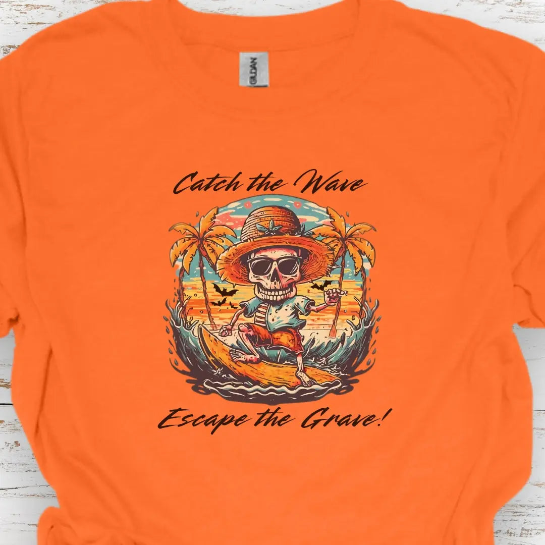 Orange T-shirt with Skeleton surfing that says Catch the Wave