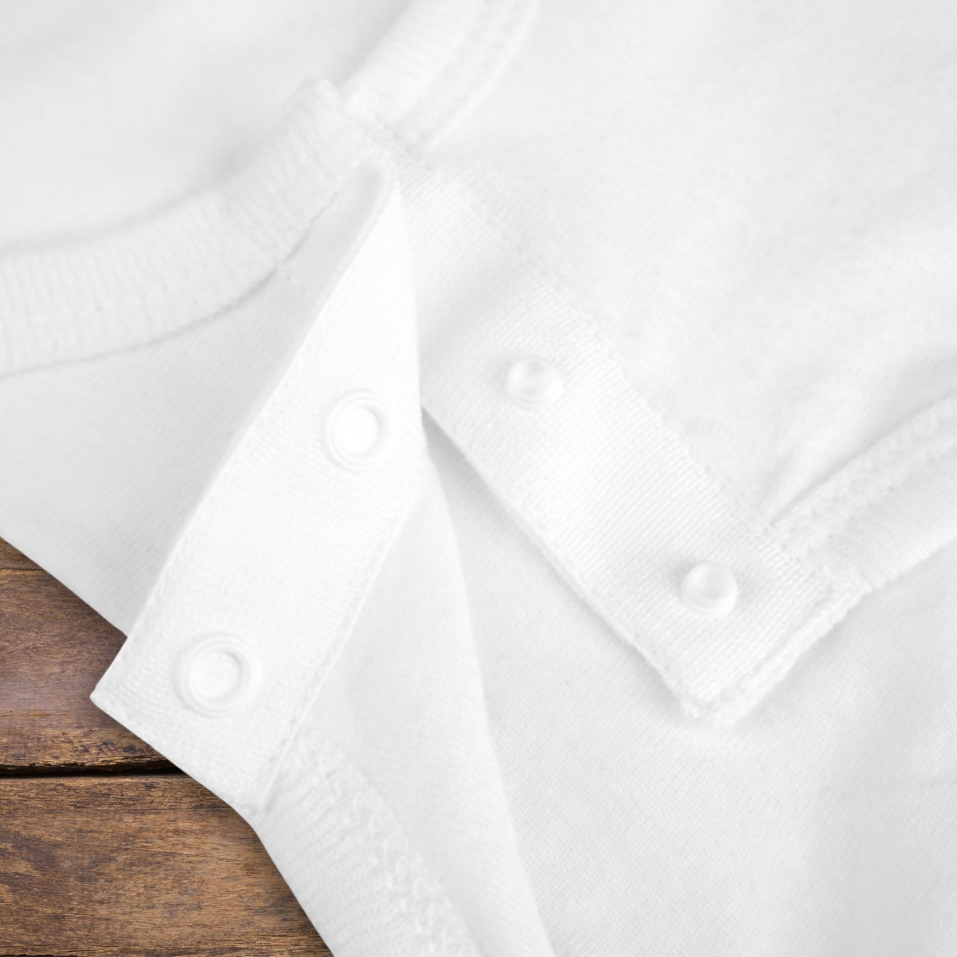 Close-up of snaps on baby bodysuit.