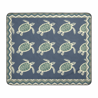 Blanket with sea turtle pattern on a blue background and chevron frame.