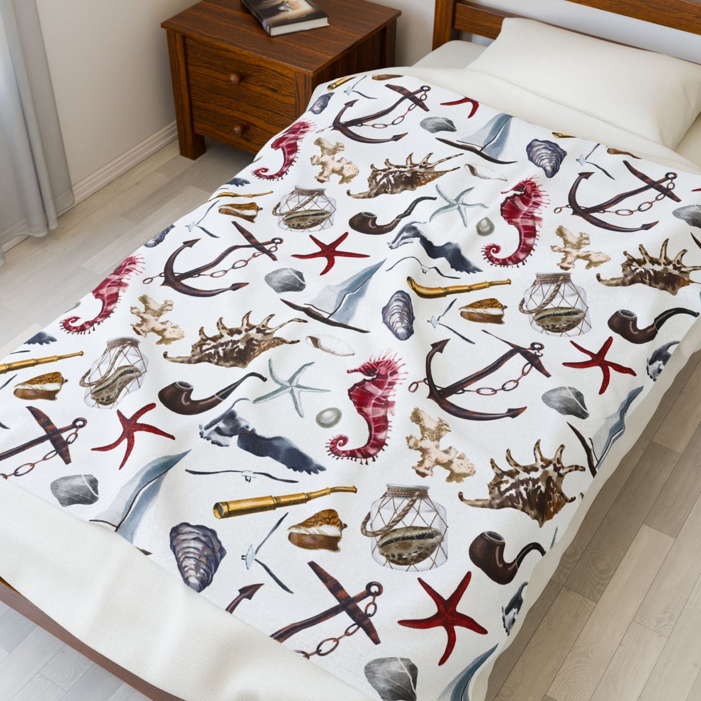 White blanket with nautical-themed design featuring anchors, stars, and shells on a white background.