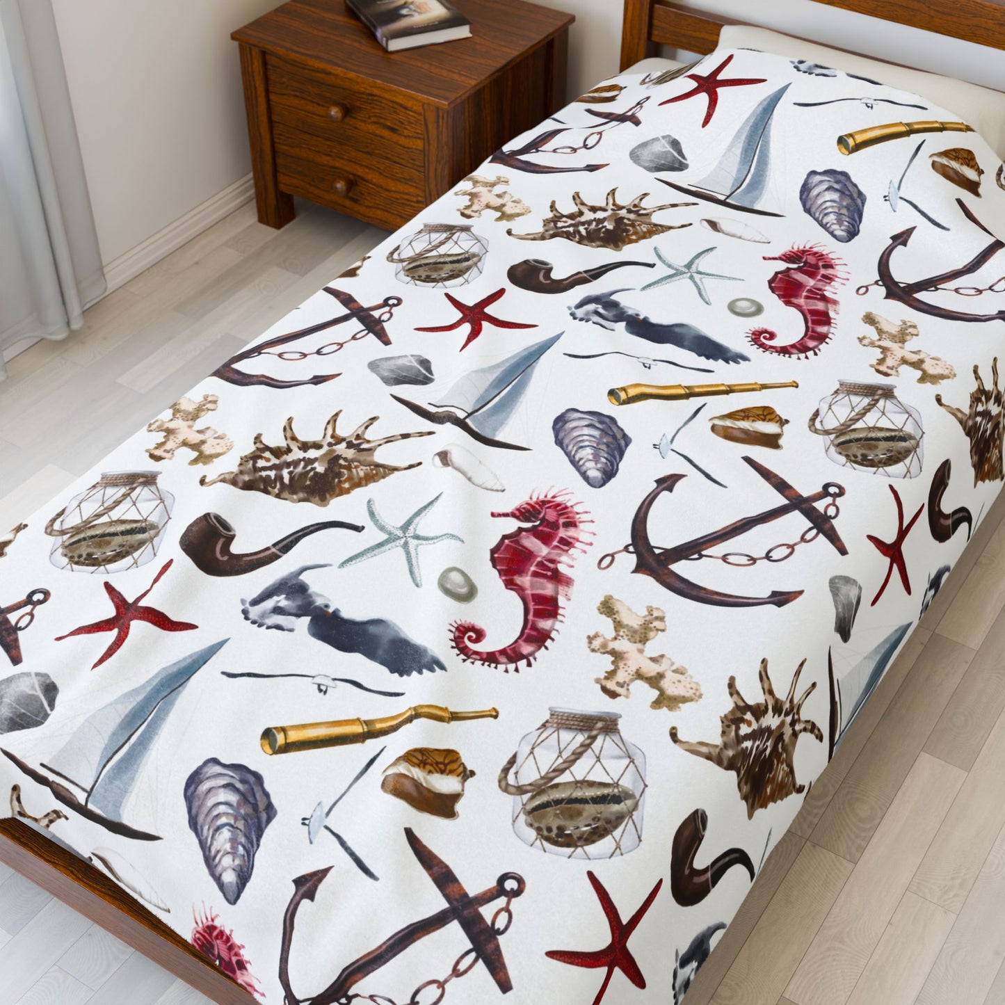 Bedspread with nautical-themed design featuring anchors, stars, and seahorses on a bed in a room.