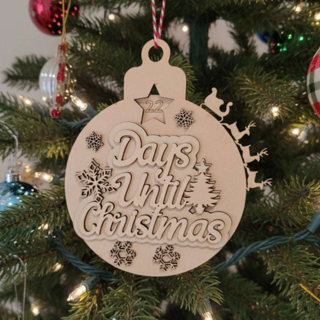 Decorative ornament counting 'Days Until Christmas' on a Christmas tree.