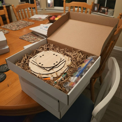 Open cardboard box with a wooden product inside on a desk.