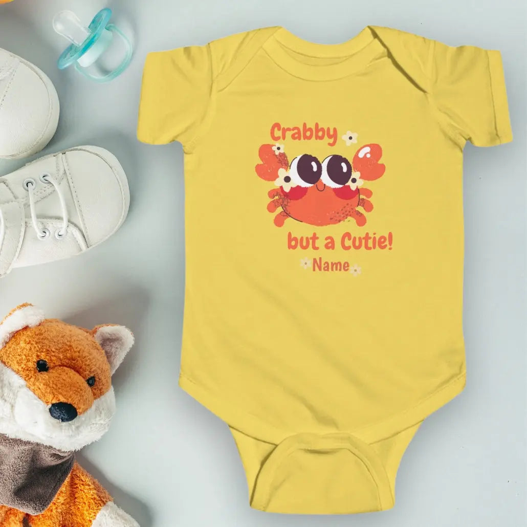 Butter Yellow short sleeved body suit with cartoon crab that says crabby but a cutie personalized.