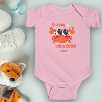 Pink short sleeved body suit with cartoon crab that says crabby but a cutie personalized.
