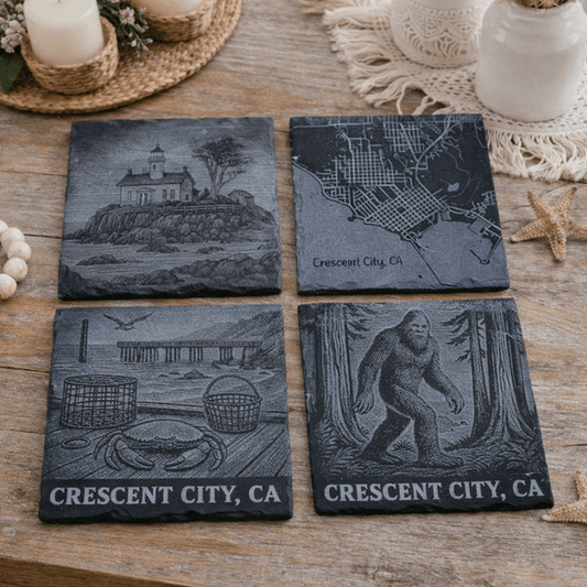 Four slate coasters with engraved designs and 'Crescent City, CA' text.