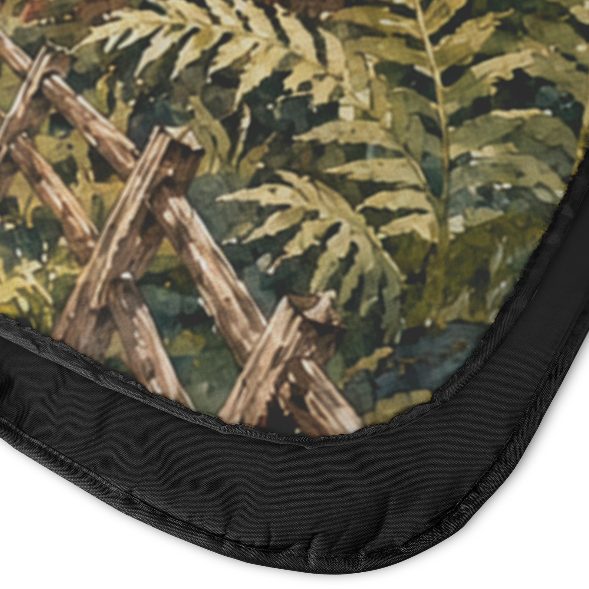Corner view showing front and back of Crescent City California outdoor blanket featuring redwood trees, ocean cliffs, and a lighthouse with a plush fleece top and water-resistant backing.